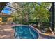 Inviting pool and spa with screened enclosure and lush landscaping at 114 Fieldstone Dr, Venice, FL 34292