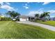 Landscaped yard with a single-story home and driveway at 1224 Pinebrook Way, Venice, FL 34285