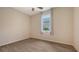 Light bedroom with gray vinyl flooring and window with curtains at 12305 Goldenrod Ave, Bradenton, FL 34212