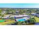 Aerial view of community pool, clubhouse, and lush landscaping at 1305 Glen Oaks E Dr # 130, Sarasota, FL 34232