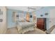 Cozy bedroom with light blue walls, double bed and dresser at 1305 Glen Oaks E Dr # 130, Sarasota, FL 34232