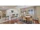 Bright dining room with kitchen access and hardwood floors at 1305 Glen Oaks E Dr # 130, Sarasota, FL 34232