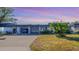 Attractive exterior of a condo with carport and well-manicured lawn at 1305 Glen Oaks E Dr # 130, Sarasota, FL 34232