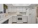 White kitchen with ample counter space and appliances at 1305 Glen Oaks E Dr # 130, Sarasota, FL 34232