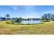 Community pond with fountain and lush landscaping at 1305 Glen Oaks E Dr # 130, Sarasota, FL 34232