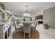 Elegant dining room with round table, chandelier, and view of the kitchen at 13325 Sunset Shore Cir, Riverview, FL 33579