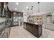 Modern kitchen with dark cabinetry, stainless steel appliances, and granite countertops at 13325 Sunset Shore Cir, Riverview, FL 33579