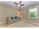 Cozy bedroom with sofa and large window at 13534 5Th Ne Ave, Bradenton, FL 34212