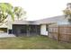 Spacious backyard with lawn, fencing, and covered lanai perfect for outdoor living at 1416 Glenmere Dr, Brandon, FL 33511