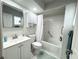 Bright bathroom featuring a white vanity, medicine cabinet and a shower/tub combo with white shower curtain at 1416 Glenmere Dr, Brandon, FL 33511