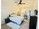 Bright bedroom featuring vaulted ceilings, wood-look floors, accent rug, and iron bed frame at 1416 Glenmere Dr, Brandon, FL 33511