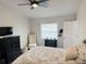 Cozy bedroom featuring a ceiling fan, dresser, tufted chair, and patterned bedding with matching pillows at 1416 Glenmere Dr, Brandon, FL 33511