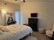 Comfortable bedroom with a ceiling fan, TV, dresser, vanity, and cushioned chair at 1416 Glenmere Dr, Brandon, FL 33511