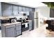 Modern kitchen with gray cabinets, stainless steel appliances, and a bright skylight at 1416 Glenmere Dr, Brandon, FL 33511