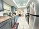 Modern kitchen featuring updated gray cabinetry, countertops, stainless steel appliances and tile flooring at 1416 Glenmere Dr, Brandon, FL 33511