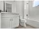 Bathroom with white cabinets and countertops featuring a shower and tub at 17966 Palmiste Dr, Bradenton, FL 34202