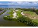 Aerial view of golf course, lake, and waterfront property at 1912 Harbourside Dr # 603, Longboat Key, FL 34228