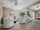 Relaxing sunroom with white chairs, tiled floors, and plenty of natural light at 1930 Alta Vista St, Sarasota, FL 34236