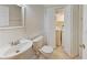 Bright bathroom featuring a toilet and sink with a laundry area behind folding doors at 209 Dragons Fire Pl, Valrico, FL 33594