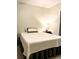Neat bedroom with bed, side table, and matching lamp, and a decorative pillow at 209 Dragons Fire Pl, Valrico, FL 33594