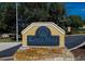 Kings Mill Townhomes community sign with a stone base, set amongst lush trees at 209 Dragons Fire Pl, Valrico, FL 33594