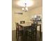 Cozy dining area featuring a wooden dining table, chairs, and a view into the kitchen at 209 Dragons Fire Pl, Valrico, FL 33594
