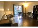Comfortable living room with hardwood floors, a sofa, and a sliding glass door to the outside at 209 Dragons Fire Pl, Valrico, FL 33594