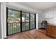 Bright home office features built-in shelving and sliding glass doors leading to a balcony at 2522 Clubhouse Dr # 204, Sarasota, FL 34232