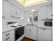 White kitchen with updated appliances and wood flooring at 2522 Clubhouse Dr # 204, Sarasota, FL 34232