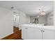 Kitchen features white cabinets, breakfast bar, and wood floors at 2522 Clubhouse Dr # 204, Sarasota, FL 34232