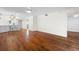 Open living area with hardwood floors and kitchen access at 2522 Clubhouse Dr # 204, Sarasota, FL 34232