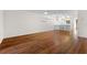 Bright living room with hardwood floors and kitchen view at 2522 Clubhouse Dr # 204, Sarasota, FL 34232