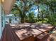 Exterior view of a spacious wooden deck bordered by lush trees in a secluded backyard at 2724 Ashton Rd, Sarasota, FL 34231