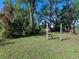 Large backyard with lush landscaping and a wooden structure at 2724 Ashton Rd, Sarasota, FL 34231