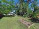 Spacious backyard with a raised garden bed and mature trees at 2724 Ashton Rd, Sarasota, FL 34231