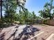 Large backyard with wooden deck and tropical landscaping at 2724 Ashton Rd, Sarasota, FL 34231