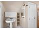 Small bathroom with pedestal sink and built-in shelving at 2724 Ashton Rd, Sarasota, FL 34231