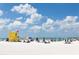 Vibrant beach scene with lifeguard stand, umbrellas, and people enjoying the sun at 2724 Ashton Rd, Sarasota, FL 34231