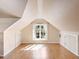 Sunlit attic bedroom with hardwood floors and window at 2724 Ashton Rd, Sarasota, FL 34231