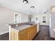 Modern kitchen features a large island with granite countertops and light wood cabinets at 2724 Ashton Rd, Sarasota, FL 34231