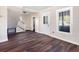 Living area with hardwood floors, white doors, and a staircase at 2724 Ashton Rd, Sarasota, FL 34231