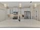 Close-up of the white kitchen island with sink, cabinets, and appliances at 27475 Janzen Ct, Englewood, FL 34223