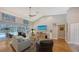 Bright living room with hardwood floors, a large TV, and sliding glass doors leading to a pool at 2910 Longleat Woods, Sarasota, FL 34235