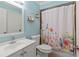 Charming bathroom with light blue walls and a floral shower curtain at 3001 Vivienda Blvd, Bradenton, FL 34207