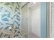 Updated bathroom with a walk-in shower, stylish wallpaper and modern fixtures at 3001 Vivienda Blvd, Bradenton, FL 34207
