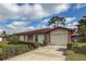 Front view of a single-story house with a garage and neat landscaping at 3001 Vivienda Blvd, Bradenton, FL 34207