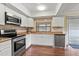 Kitchen with stainless steel appliances and white cabinetry at 3001 Vivienda Blvd, Bradenton, FL 34207