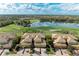 Scenic aerial view of community showcasing lake and lush golf course landscaping and mature trees at 318 Winding Brook Ln # 104, Bradenton, FL 34212