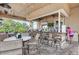 Outdoor bar area with tables, chairs, and a flat-screen TV at 318 Winding Brook Ln # 104, Bradenton, FL 34212