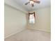 Neutral bedroom featuring a ceiling fan and window that provides natural light at 318 Winding Brook Ln # 104, Bradenton, FL 34212